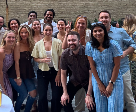 AdsLoom.net team members posing together during a party.